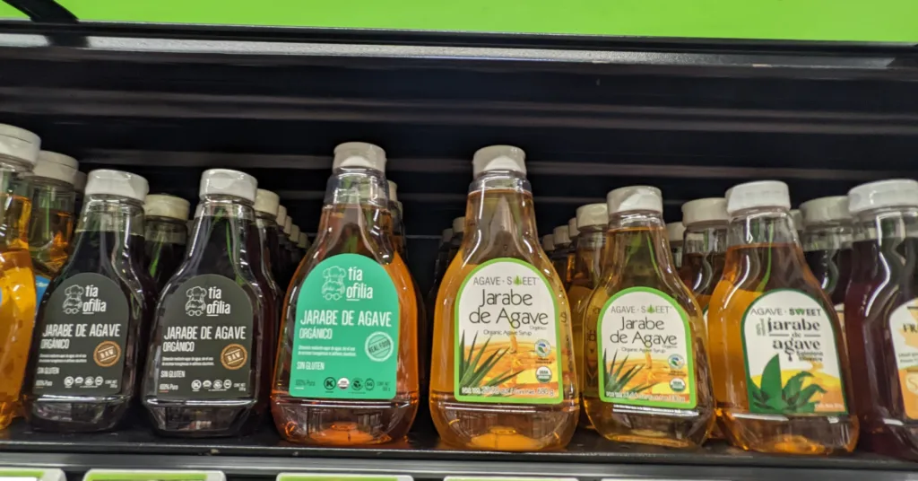 Agave syrup range ORG Different agave syrup bottles on supermarket shelf